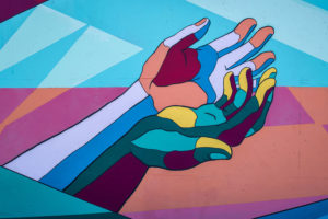A mural of outstreteched hands