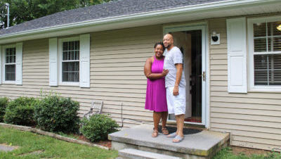 New homeowners in front of house