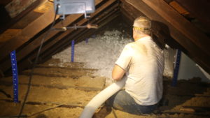 CHP Energy Solutions staff blowing insultation in attic