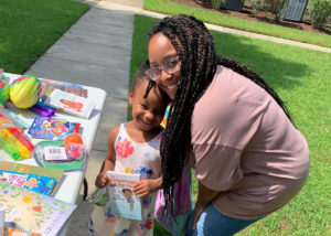 A participant in CHP Reads picks out a book at Belleville Meadows Apartments