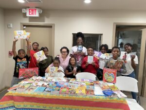 Young residents receiving books through the CHP Reads! program.