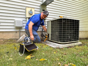 A CHP Energy Solutions staff member with an HVAC system in Blacksburg