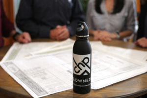 The homeownership team with a branded water bottle in the foreground