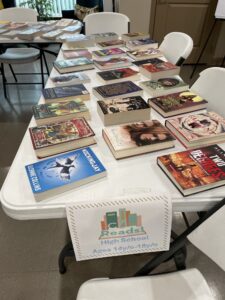 Table with books for youth residents to select.
