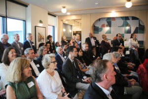 Attendees listen to remarks at the Witter Place ribbon cutting
